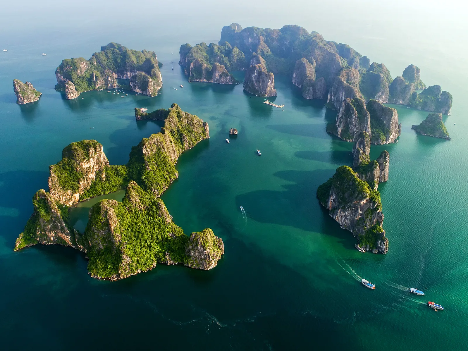 Aerial view of limestone karst islands rising from the emerald waters of Halong Bay, Vietnam.