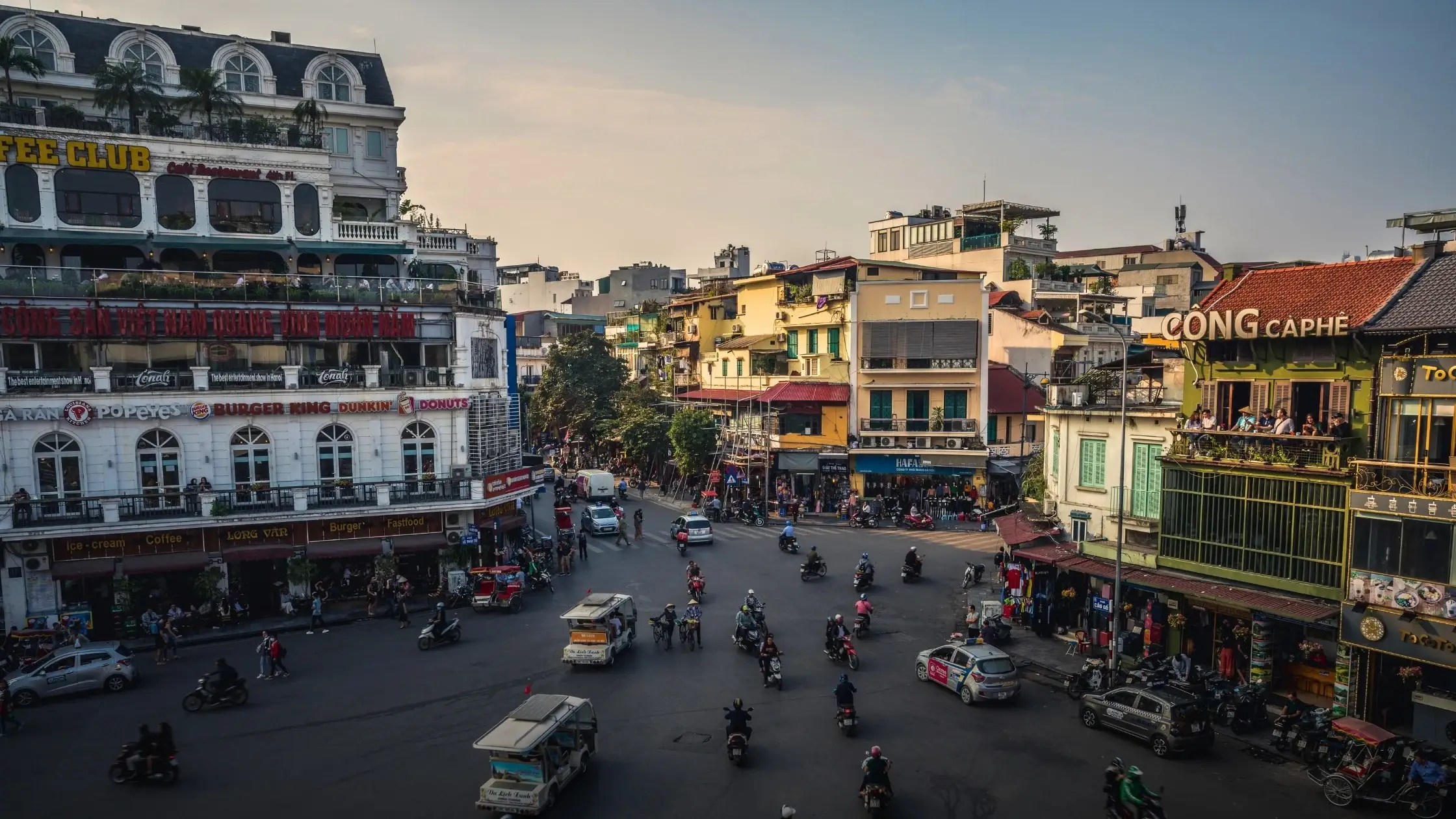 Motorbikes and shopfronts on a narrow street in the Hanoi Old Quarter