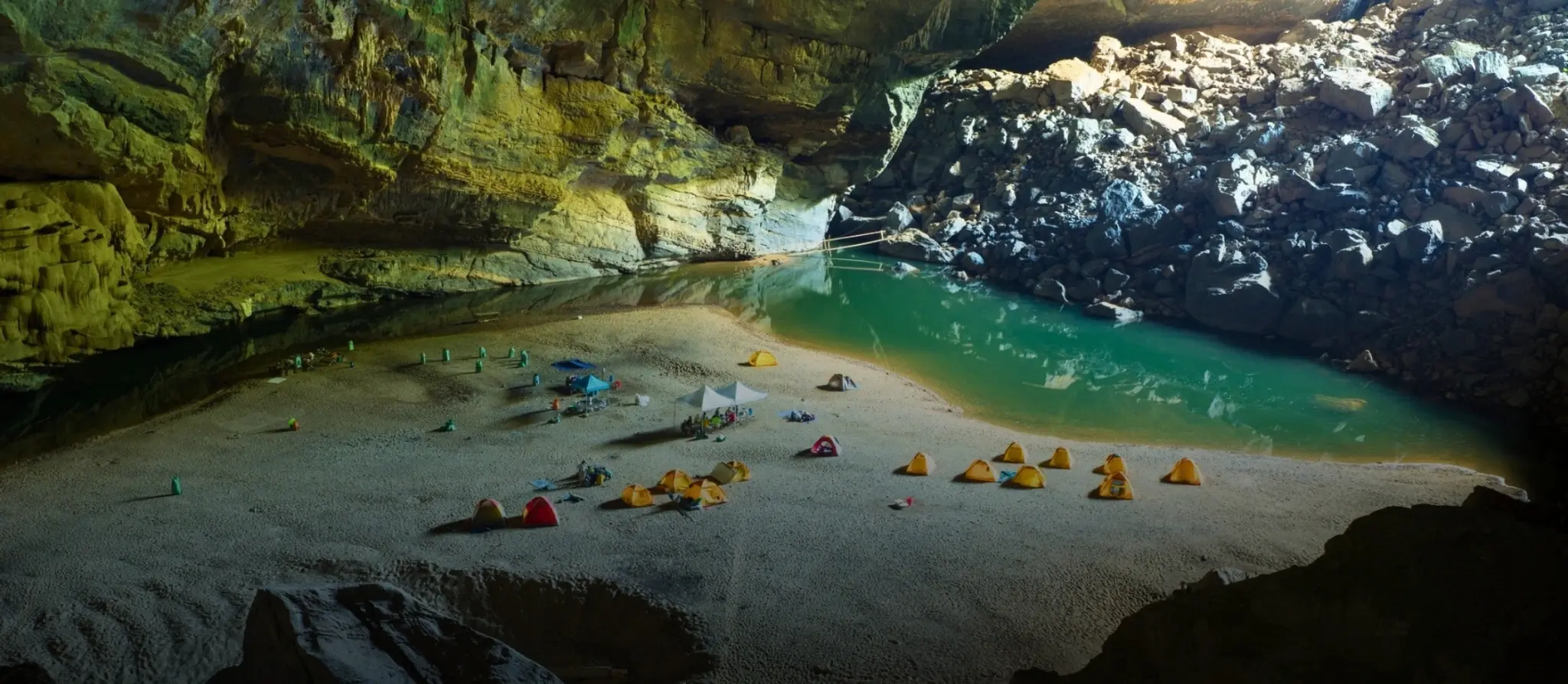 Vast cave chamber lit by a shaft of daylight in Quang Binh