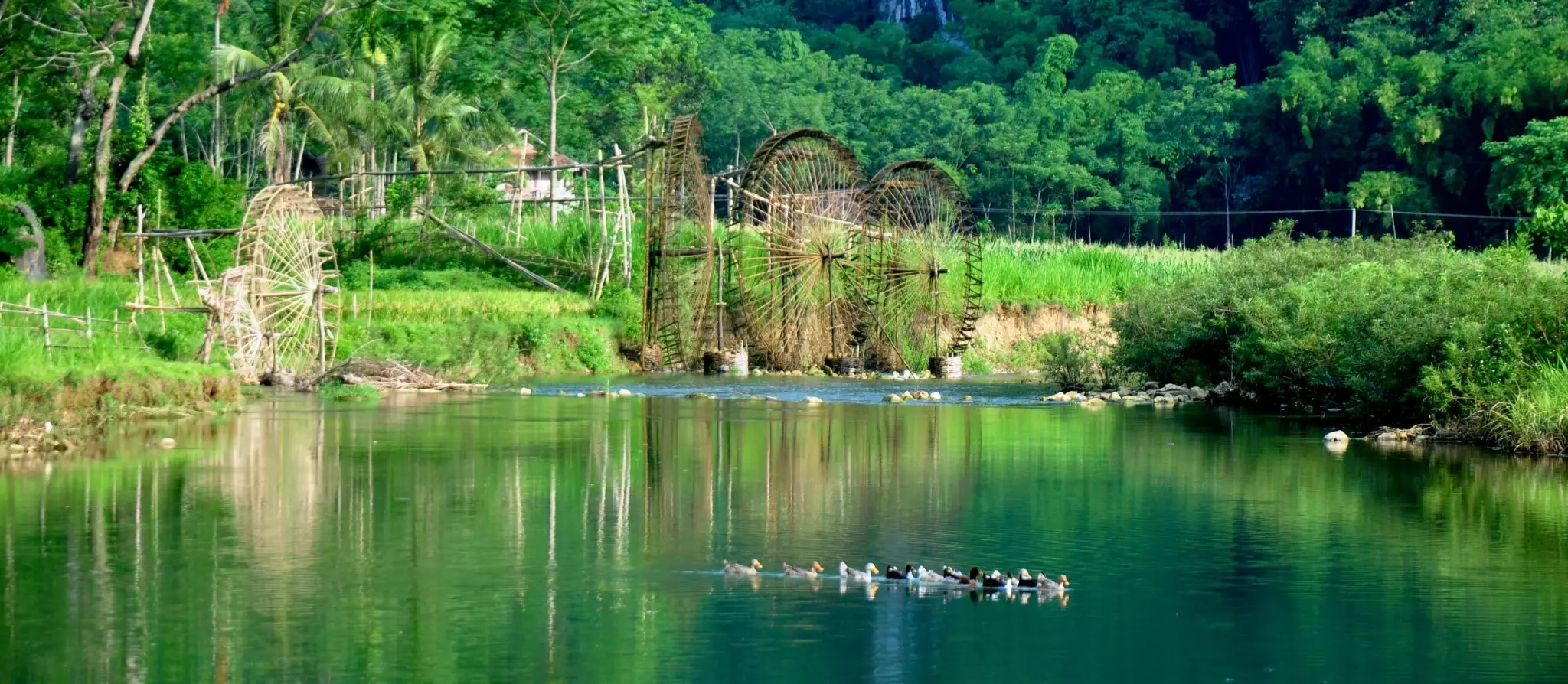 Bamboo water wheel lifting water into rice terraces in Pu Luong