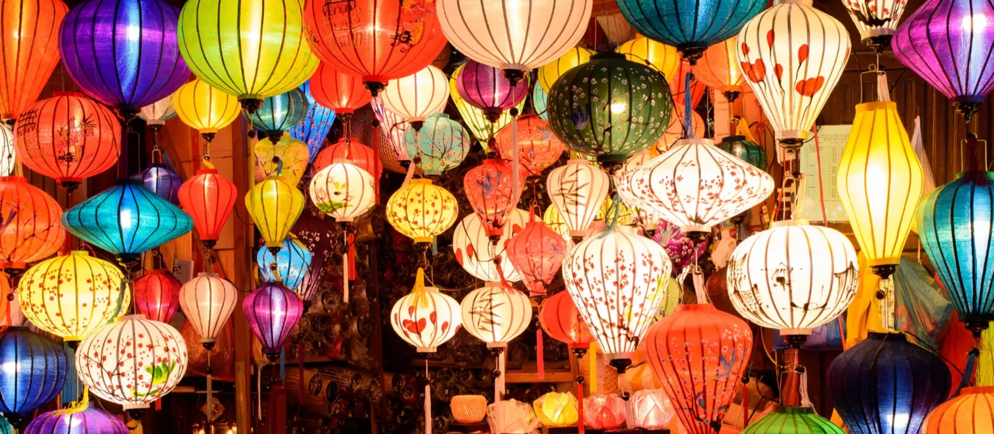 Silk lanterns hanging above a street in Hoi An at night