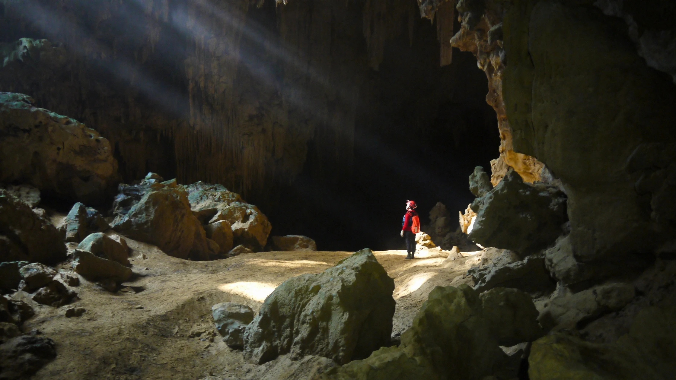 Trekkers crossing a river valley in the limestone country of Quang Binh