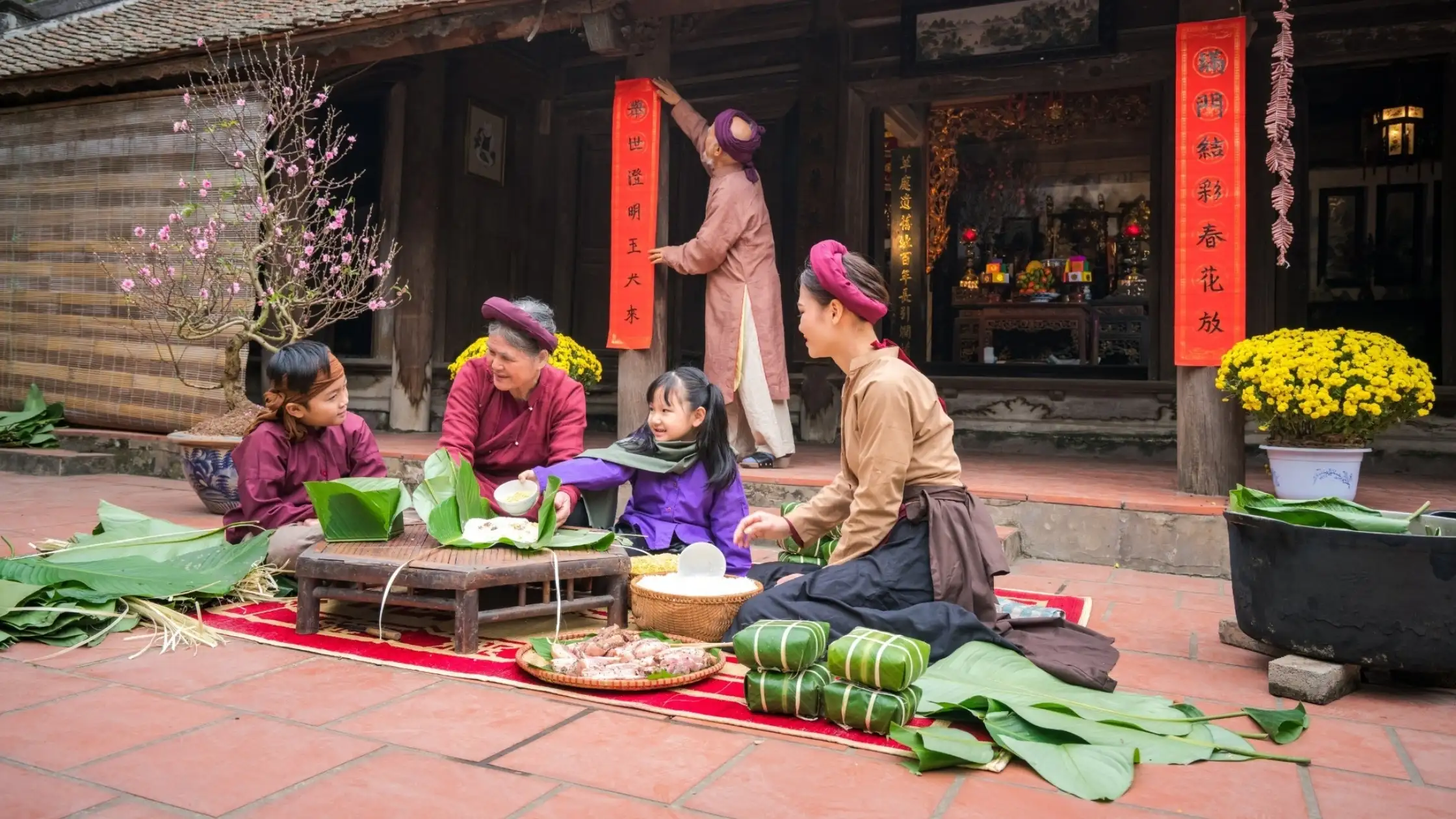 Local family and travellers sharing a meal in a village house in Vietnam